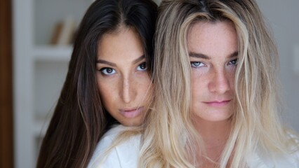 Close-up face of beautiful self-confident women. Relationships in a lesbian family. A blonde lesbian is happy with her brunette friend, love in the LGBT community between women.