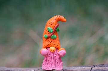 Colorful little gnome with a pink beard close-up. Fabulous figurines.