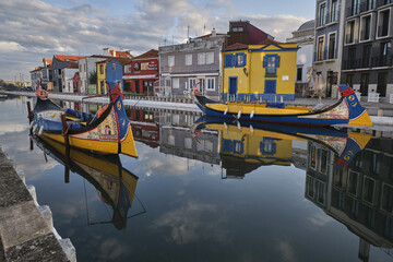 Fototapeta na wymiar Traditional colorful boats called Moliceiros moored on the central canal in Aveiro, Portugal