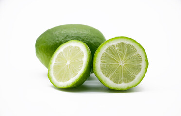 whole and slice green Lemons isolated on white background
