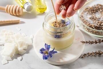 Set tools for homemade natural eco-friendly soy wax candles, wick, perfume, essential oil on a marble table. Making process. Trendy DIY. Craft hobby, small business, artisan products concept