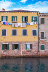 Fototapeta na wymiar Colorful houses near the water in Venice, Italy