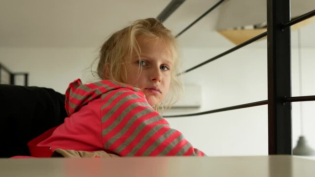 
A distraught girl looks at the camera