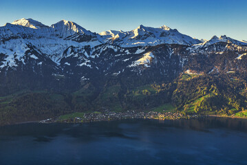 The snow-covered Swiss Alps and the view of  Thun lake.