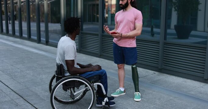 Multiracial friends with disability having fun outdoor 
