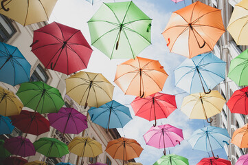 Fototapeta na wymiar Colorful umbrellas in the sky in Timisoara.