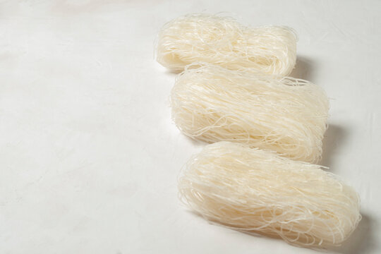 raw Korean starch tangen noodles on a gray background, side view, copy space.