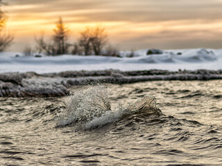 winter landscape from the sea shore, blurred wave slag against frozen ice cubes, blurred background