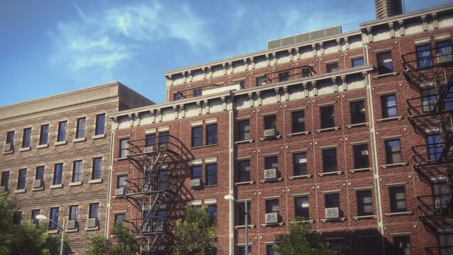 Low Angle Panning Shot Of A VFX Animated Brick Multi-Storey Apartment Building. Old Renovated Brownstone House. Urban Landscape During Day Time Of A House With Emergency Stairs And Air Conditioning.