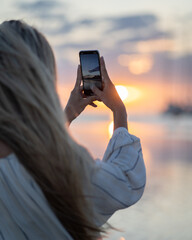 two girls in bikini spending a day on the beach at sunset