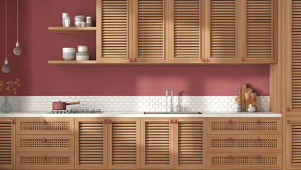 Vintage wooden kitchen in white and red tones. Cabinets with shutters and rattan drawers, sink and gas hob, pottery and decors. Parquet, retro interior design, front view, close up