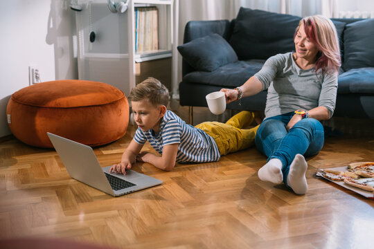 mother and son watching laptop at home