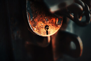 A large rusty old barn padlock with a chain closes the room. Safety. Tools.