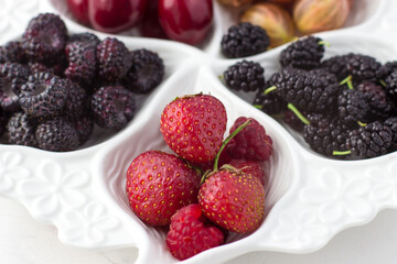 Close-up of strawberries on a fruit plate on a white background. Ripe berries. Vitamins and a healthy lifestyle