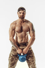 Fototapeta premium Muscular and fit young bodybuilder fitness male model posing over white background. 