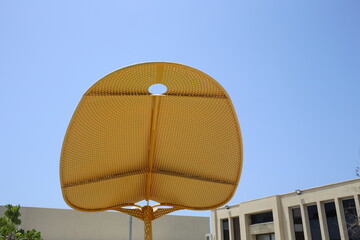 Sun umbrella in a city park on the Mediterranean coast.