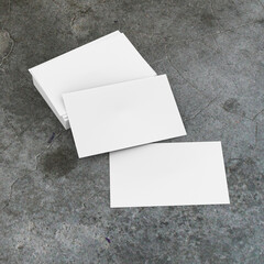 White business card to insert information. Made on a concrete background.