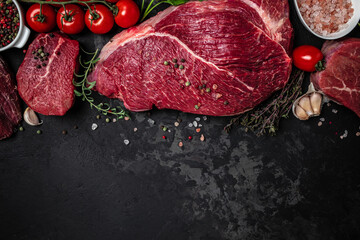 Beef tenderloin fillet with rosemary and spices on a dark background. Preparing fresh beef steak ready to cook, Long banner format. top view - obrazy, fototapety, plakaty