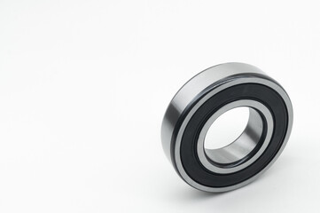 Closed type bearing for modern equipment and machines on a white background. Italian ball bearing with protective covers. Selective focus