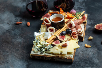 Cheese platter. Assorted cheese, wine ham, fruit, bread sticks, nuts. banner, menu, recipe place for text, top view