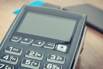 Payment terminal, credit card and smartphone. Cashless paying for shopping. Finance concept