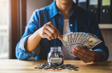 woman counting dollar bills and Put coins in a jar to save money for the future. after retirement and record keeping of income, expenditure, savings and financial concepts.