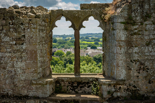 A view through the window from Raglan castle walls out onto the rolling hills of South Wales on a beautiful sunny day. The medieval structure has suffered over the years but this frame has preserved