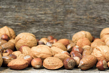 Assorted nuts on wooden desk with copy space