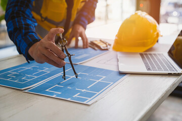 Architects or engineering work with blueprints and discuss projects together at the meeting in the office, and structural analysis of project types.