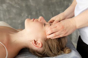 Cropped close up female osteopath fix patient neck and head to cure spasm. Alternative medicine....