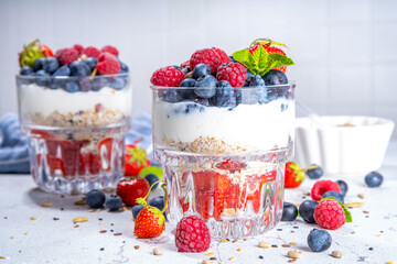 American independence holiday food, july 4 breakfast recipe idea. Summer diet healthy breakfast layered parfait dessert in a glass of yogurt, oatmeal, blueberries, strawberry berries