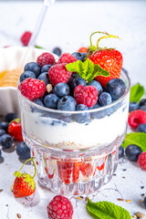 American independence holiday food, july 4 breakfast recipe idea. Summer diet healthy breakfast layered parfait dessert in a glass of yogurt, oatmeal, blueberries, strawberry berries