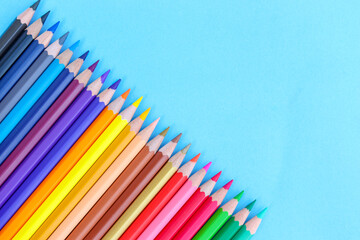 colored pencils with copy space on blue background educational concept