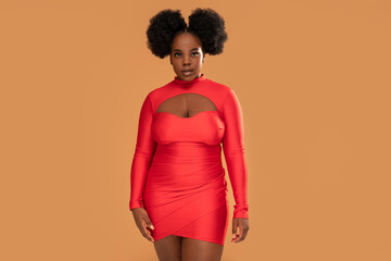 Beautiful african Woman posing in red mini dress, looking at the camera. Afro hairstyle, glamour...