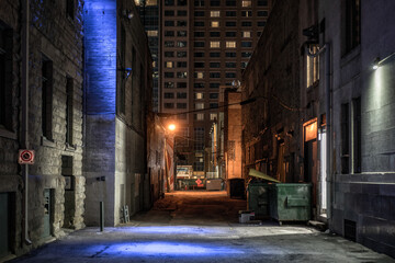 Dark empty illuminated back alley