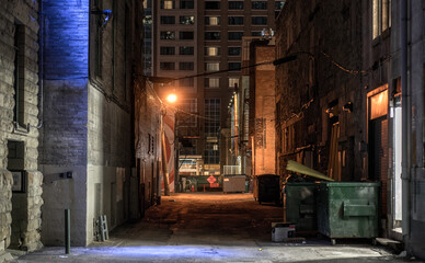 Dark empty illuminated back alley