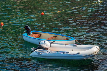 Close-up of two empty small recreational motor boats moored in a port. Mediterranean sea, Gulf of La Spezia, Liguria, Italy, Europe.