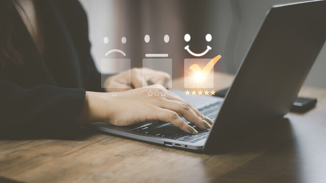 Customer service and Satisfaction concept women's hands doing online assessments in the satisfaction rating the popular service company allows customers in order to improve and develop the organizatio