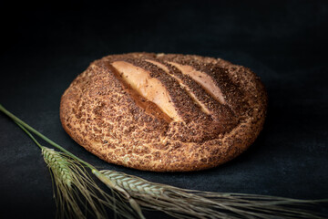 Loaf of homemade Chuta bread with ears of wheat
