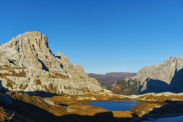 Alpine lakes near Lavaredo refuge in mountain valley on sunny day, Tre Cime National Park, Dolomites Mountains