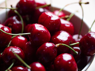 Red cherry. Close-up ripe red cherries with stem in a bowl. Tasty summer and garden fruits. 