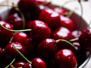 Red cherry. Close-up ripe red cherries with stem in a bowl. Tasty summer and garden fruits. 