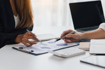 Meeting with colleagues to discuss financial reports for strategic analysis and business investment planning.