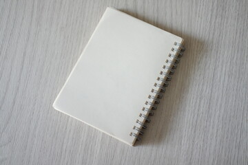 Notebook placed on a wooden table top view