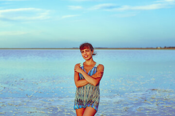 Fototapeta na wymiar a girl in a swimsuit on a salt lake