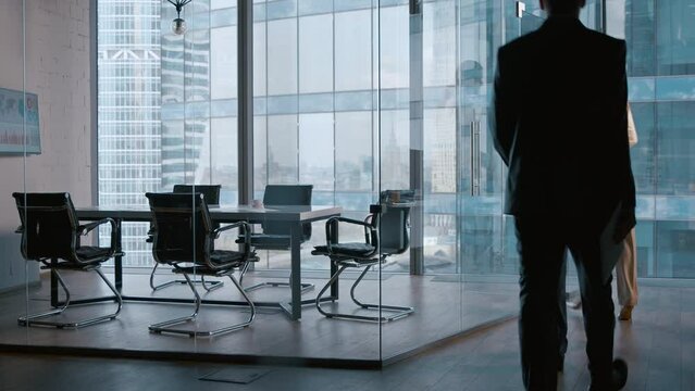 Young business people going to a meeting in boardroom