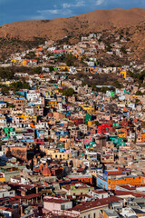 Panoramic urban landscape, the historical old town of Guanajuato city, in Mexico. Colorful, traditional colonial downtown neighborhood houses. Mexican architecture, rooftops, townscape.