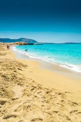 Fototapeta na wymiar Falassarna, Greece, 13 June 2022: Tourists on the sandy beach of Falassarna in Crete Island