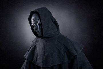 Fototapeta na wymiar Mysterious humanoid alien at night over dark misty background