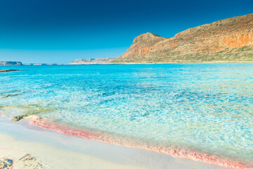 Pink sand and crystal clear water in the Balos Lagoon, Crete,  Greece